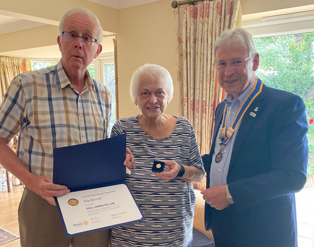 Club Secretary John Ralph (left) and President Graham Dawson (right) present Fay with her award